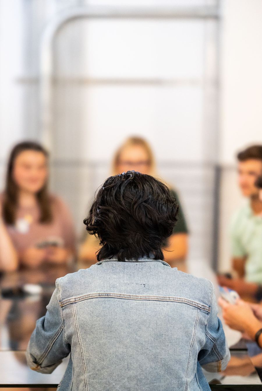 A researcher facilitating a session, seen from behind